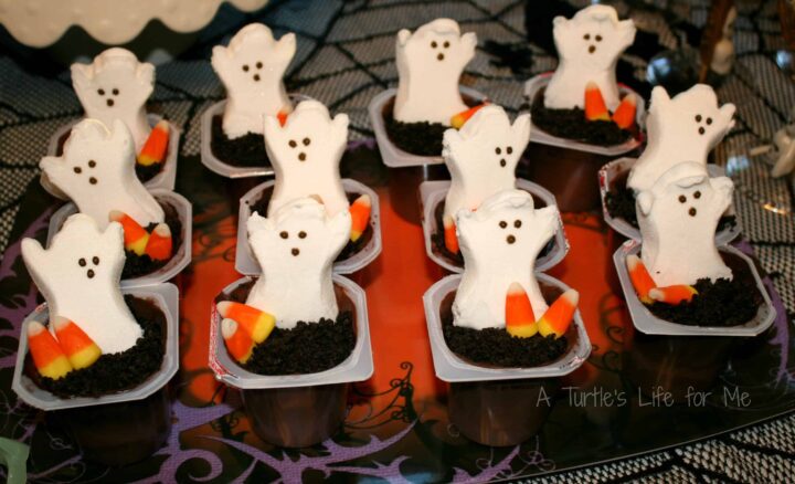 halloween birthday party pudding decorated like a graveyard with a ghost coming up