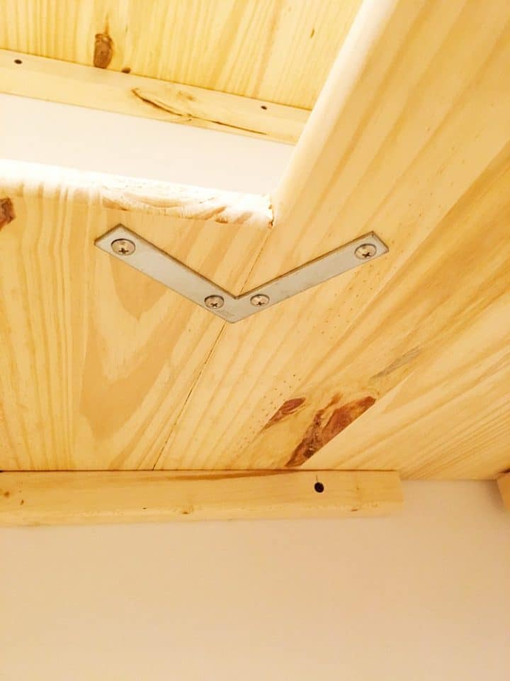 An L bracket supports corner shelves in a custom DIY pantry project